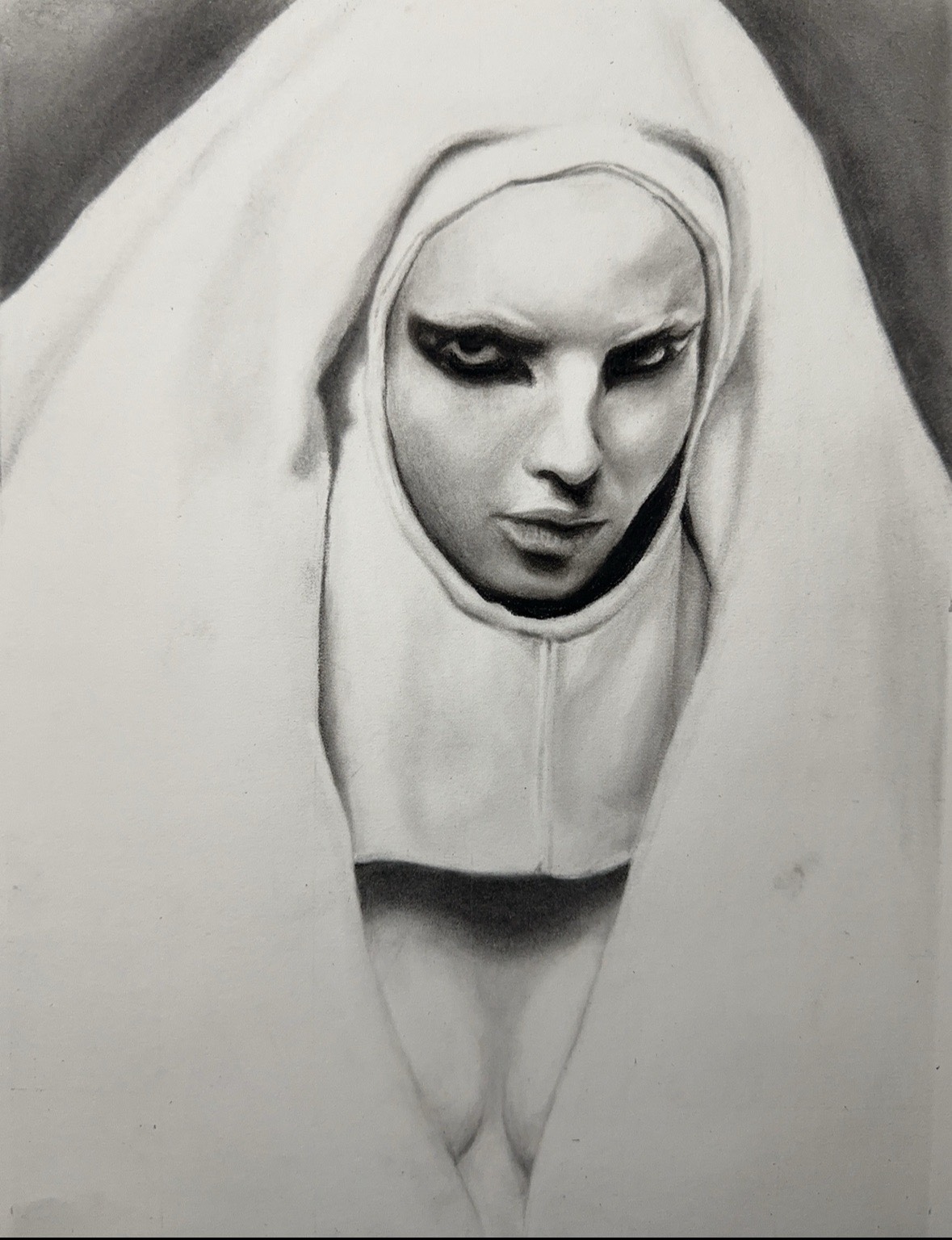 A charcoal drawing of a nun who is looking angrily at the viewer. She wears black makeup around her eyes.
